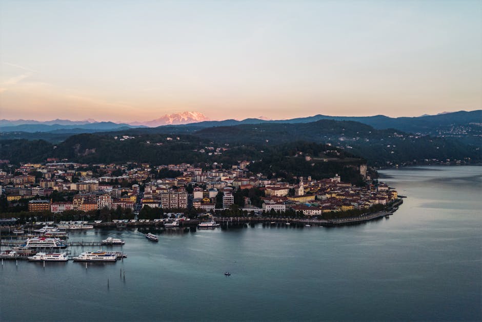 A breathtaking aerial shot of Lake Maggiore with the Alps in the backdrop during sunset